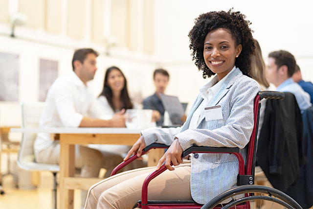 African american woman in wheelchair maintaining HR AAP and OFCCP disability compliance